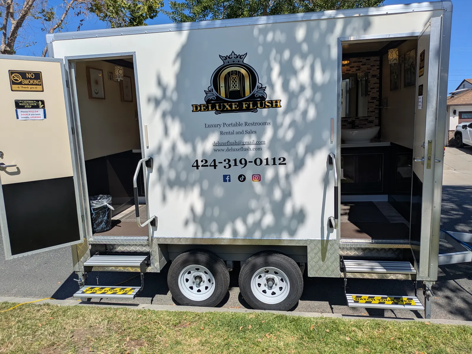 Deluxe Flush luxury restroom trailer exterior with both entrance doors open, ready for guests